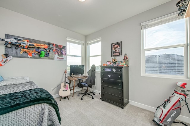 bedroom featuring carpet and baseboards