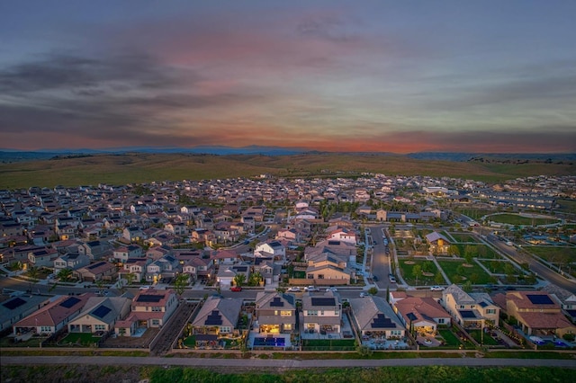 aerial view at dusk featuring a residential view