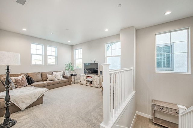 living area with recessed lighting, visible vents, baseboards, and carpet floors