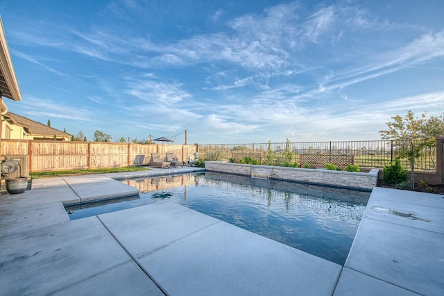 view of swimming pool featuring a patio area, a fenced in pool, and a fenced backyard