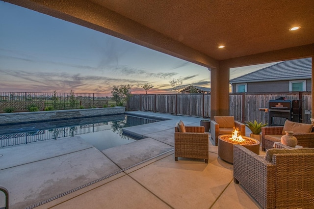 view of swimming pool with an outdoor fire pit, a patio area, a fenced in pool, and a fenced backyard