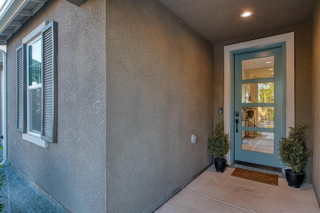 entrance to property with stucco siding