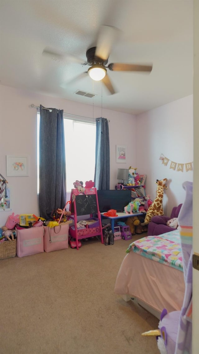 carpeted bedroom featuring ceiling fan and visible vents