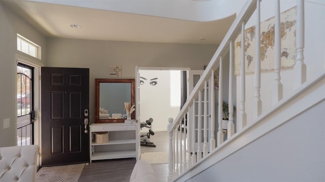 foyer featuring stairway and wood finished floors