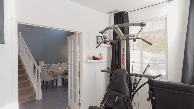 exercise area featuring visible vents and wood finished floors