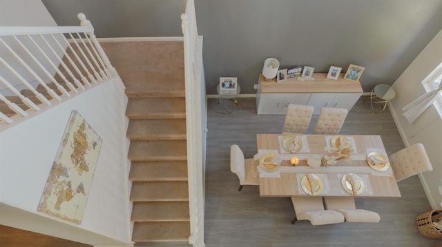 stairs featuring wood finished floors and baseboards