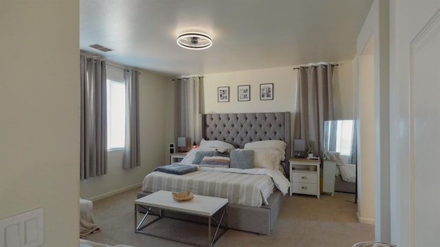 bedroom featuring light carpet, visible vents, and baseboards