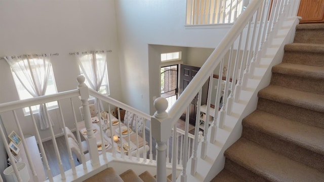 stairs featuring a towering ceiling
