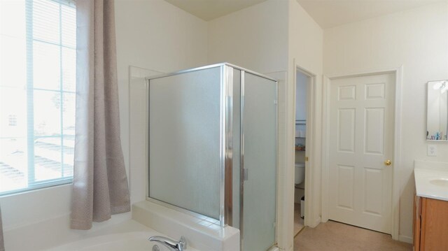full bathroom with toilet, a stall shower, a garden tub, and vanity