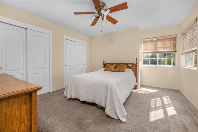 6305 N Marty Ave, Fresno, CA 93711 - bedroom featuring carpet flooring, baseboards, two closets, and ceiling fan