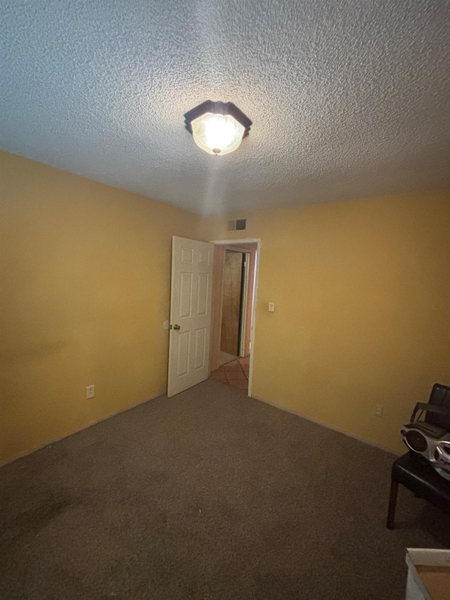 1225 Pontiac Ave, Clovis, CA 93612 - carpeted spare room featuring a textured ceiling