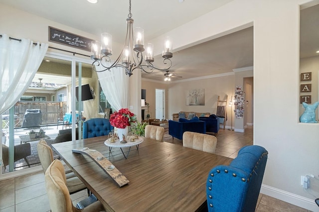 dining area with crown molding, baseboards, tile patterned floors, and ceiling fan with notable chandelier