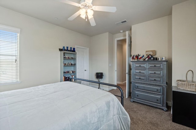 carpeted bedroom with visible vents, ceiling fan, and baseboards