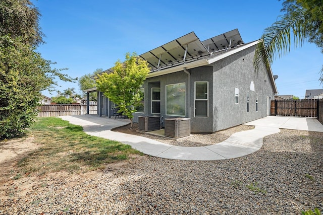 4650 W Roberts Ave, Fresno, CA 93722 - back of property featuring stucco siding, central AC unit, a patio area, and a fenced backyard