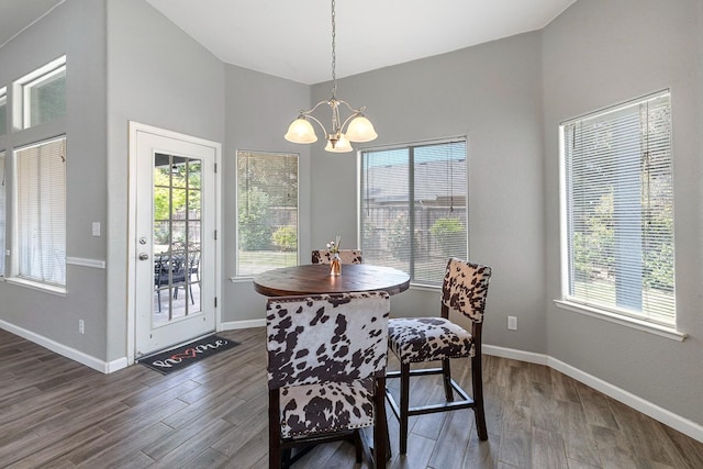 4650 W Roberts Ave, Fresno, CA 93722 - dining room featuring a chandelier, dark wood-type flooring, and baseboards