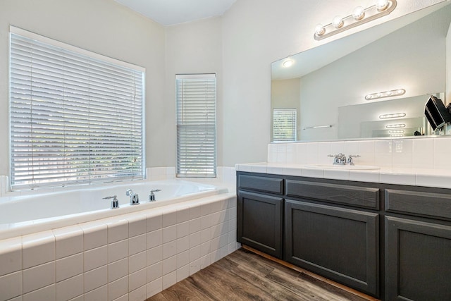 4650 W Roberts Ave, Fresno, CA 93722 - full bathroom featuring a bath, vanity, and wood finished floors