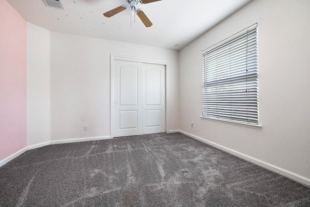 4650 W Roberts Ave, Fresno, CA 93722 - unfurnished bedroom featuring carpet flooring, baseboards, a closet, and a ceiling fan