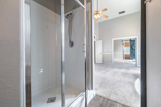 4650 W Roberts Ave, Fresno, CA 93722 - bathroom featuring ceiling fan, a stall shower, wood finished floors, and baseboards