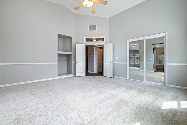4650 W Roberts Ave, Fresno, CA 93722 - unfurnished bedroom with carpet floors, high vaulted ceiling, baseboards, arched walkways, and ceiling fan