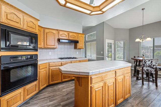 4650 W Roberts Ave, Fresno, CA 93722 - kitchen featuring black appliances, tile counters, a chandelier, and plenty of natural light