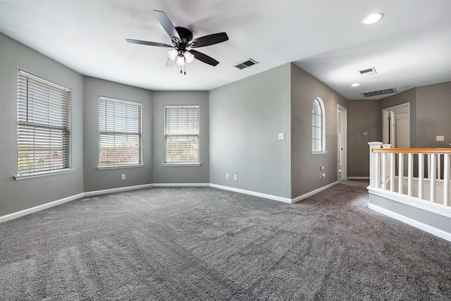 4650 W Roberts Ave, Fresno, CA 93722 - carpeted empty room featuring a ceiling fan, baseboards, and healthy amount of natural light
