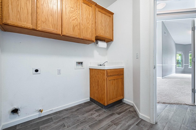 4650 W Roberts Ave, Fresno, CA 93722 - washroom with gas dryer hookup, washer hookup, wood tiled floors, and cabinet space