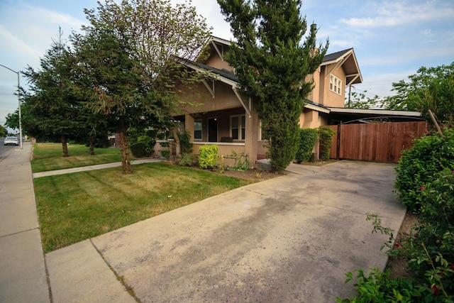 view of front of home featuring concrete driveway, stucco siding, and a front lawn
