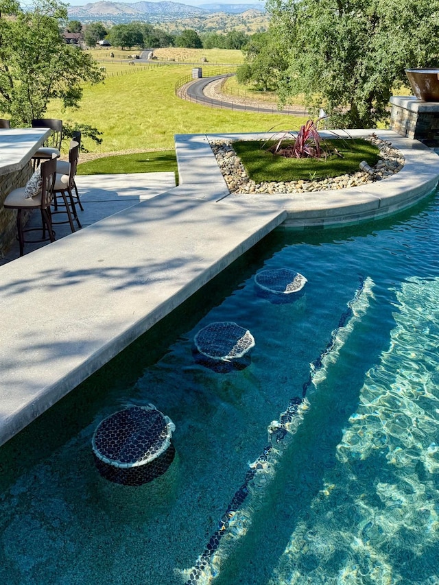 view of pool with a lawn and a patio area