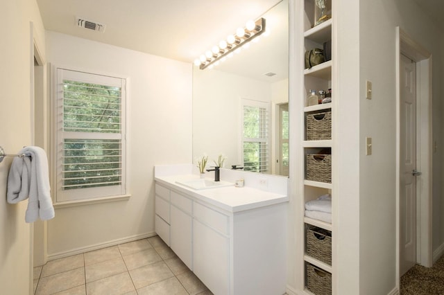 bathroom featuring tile patterned floors, visible vents, baseboards, and vanity