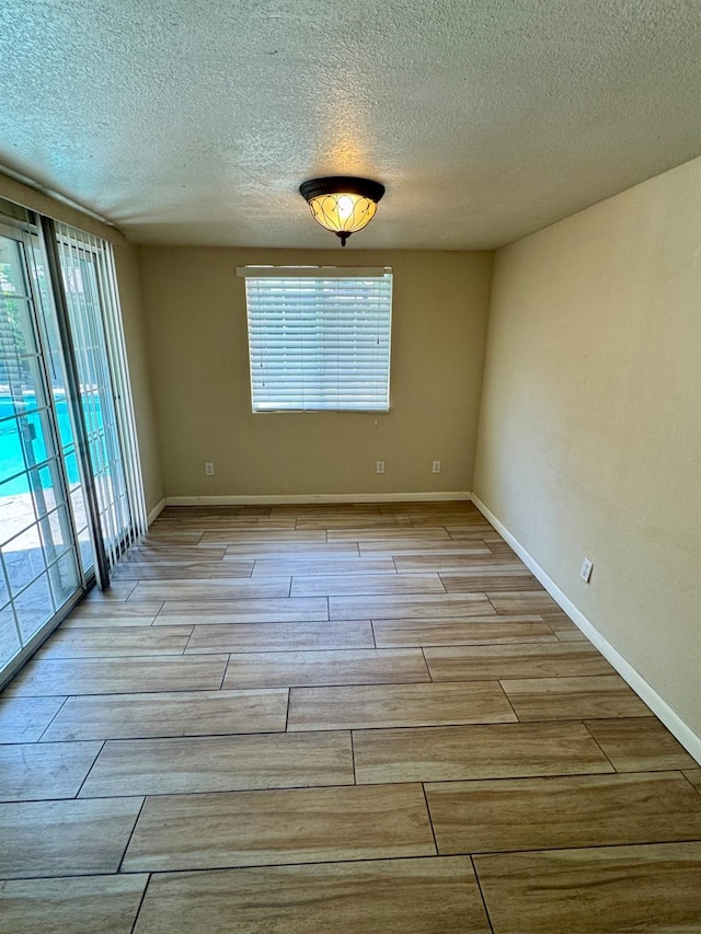 3140 Timmy Ave, Clovis, CA 93612 - empty room featuring wood tiled floors and a textured ceiling