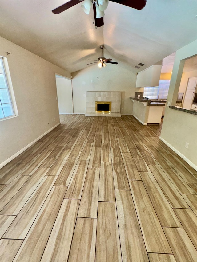 3140 Timmy Ave, Clovis, CA 93612 - unfurnished living room featuring a ceiling fan, lofted ceiling, wood finished floors, and a fireplace