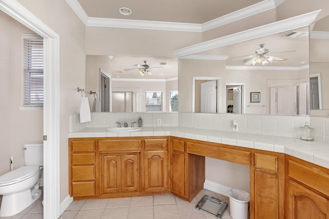 bathroom featuring toilet, tile patterned flooring, a ceiling fan, and crown molding