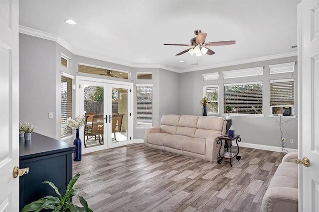 living room featuring french doors, a ceiling fan, crown molding, and wood finished floors