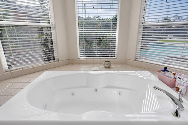 full bath featuring a jetted tub and a healthy amount of sunlight