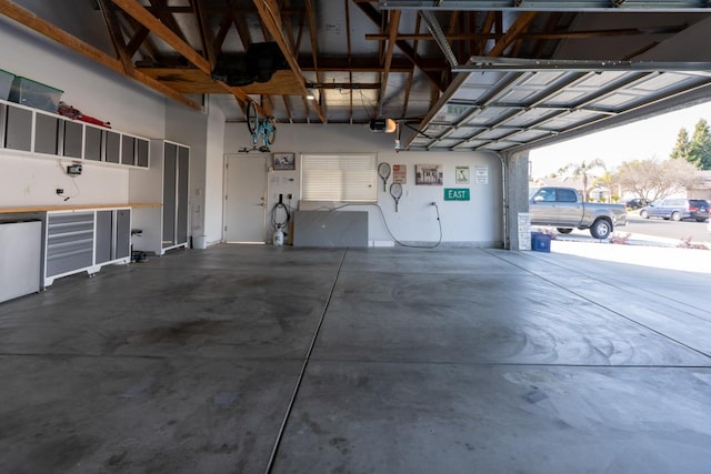 garage featuring refrigerator and a garage door opener