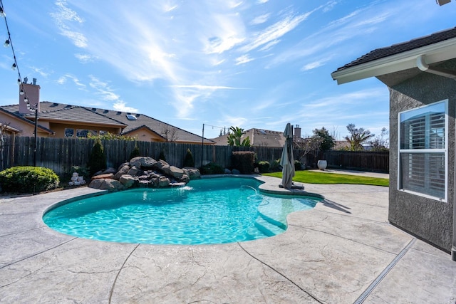 view of swimming pool featuring a patio, a fenced backyard, and a fenced in pool