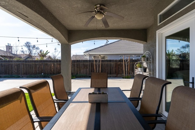 view of patio / terrace featuring a fenced backyard, ceiling fan, and outdoor dining area