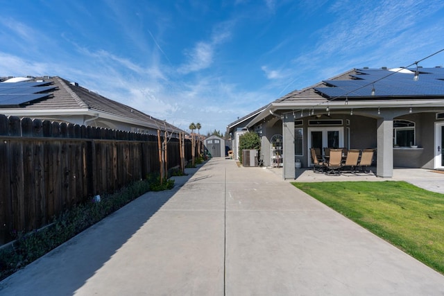 surrounding community featuring a patio area, a yard, a fenced backyard, a storage unit, and an outbuilding