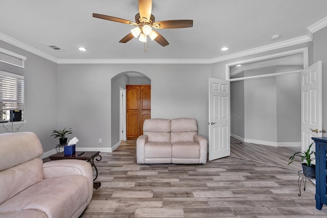 living room with arched walkways, visible vents, recessed lighting, wood finished floors, and baseboards