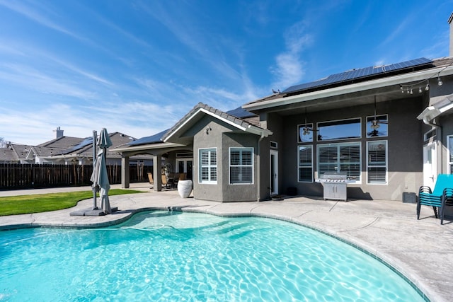 view of swimming pool featuring fence, a fenced in pool, and a patio