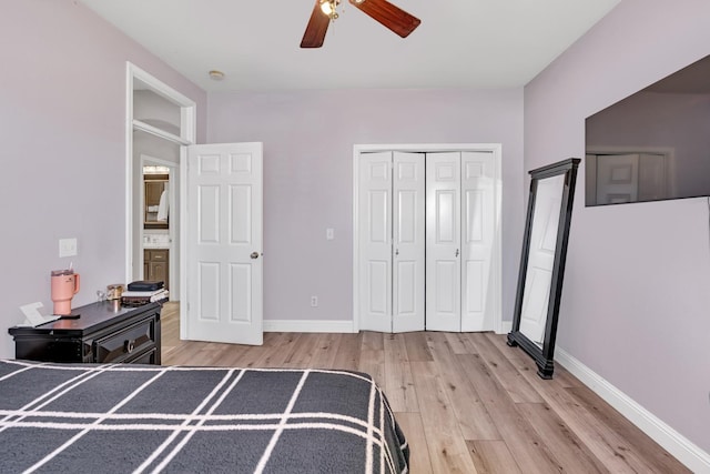bedroom featuring a closet, baseboards, a ceiling fan, and light wood-style floors