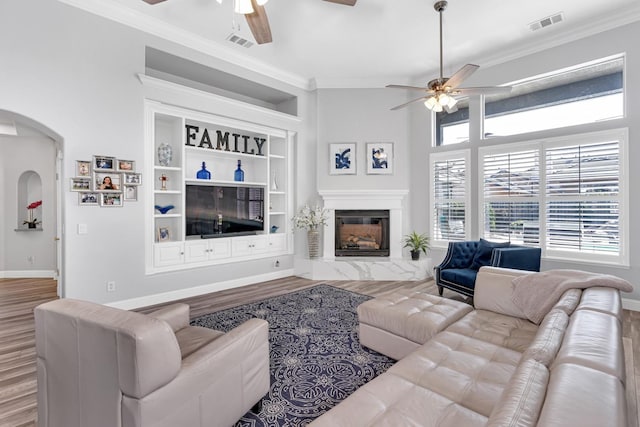 living room featuring visible vents, wood finished floors, and ceiling fan