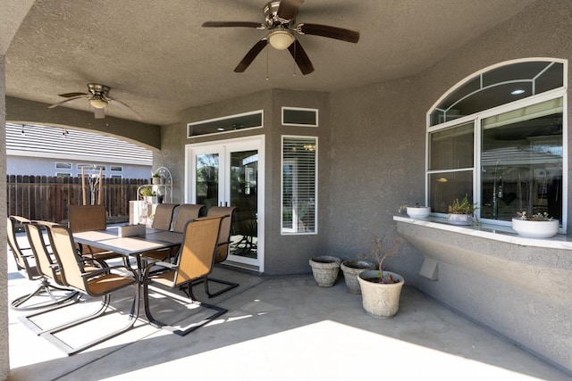 view of patio / terrace featuring ceiling fan, fence, and outdoor dining space