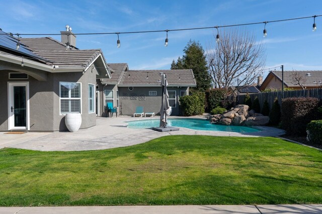 view of swimming pool with a patio area, a fenced backyard, a fenced in pool, and a lawn