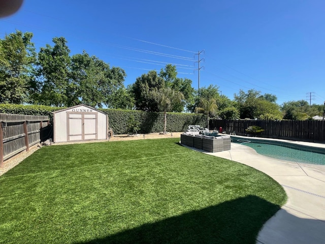 view of yard featuring a fenced backyard, an outdoor living space, an outdoor structure, a patio, and a storage unit