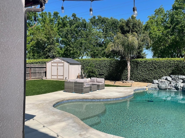 view of swimming pool featuring a patio area, a fenced backyard, an outdoor structure, an outdoor hangout area, and a storage unit