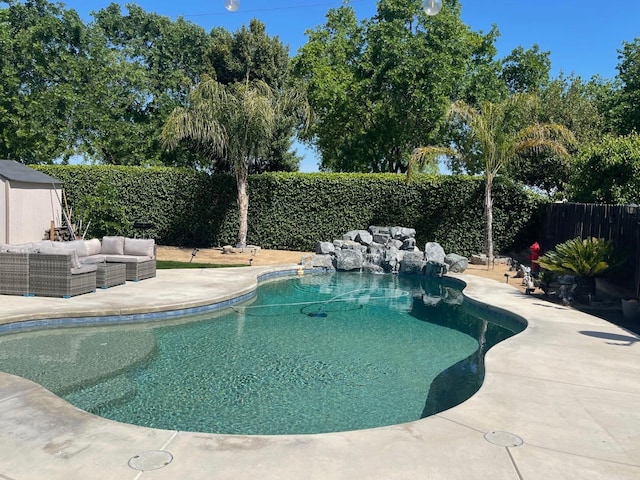 view of swimming pool with outdoor lounge area, a fenced backyard, a fenced in pool, and a patio area