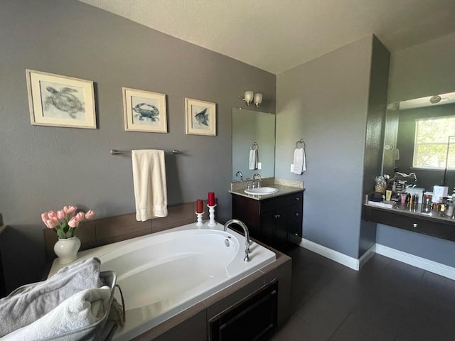 bathroom with a bath, vanity, and tile patterned floors