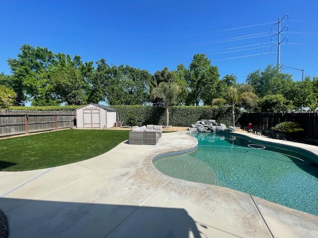 view of swimming pool featuring a storage shed, a fenced backyard, a patio area, and an outdoor hangout area