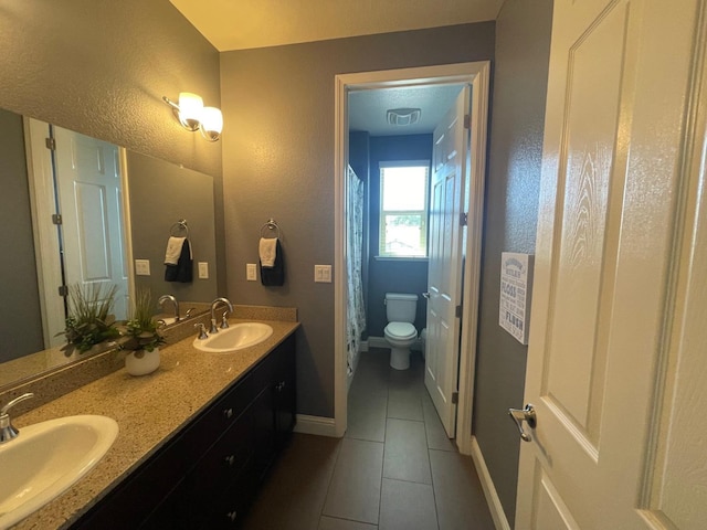 full bathroom with tile patterned flooring, baseboards, a sink, and toilet